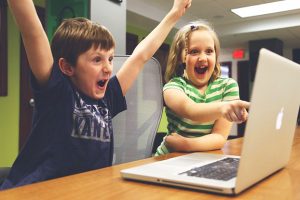 Happy children using computer
